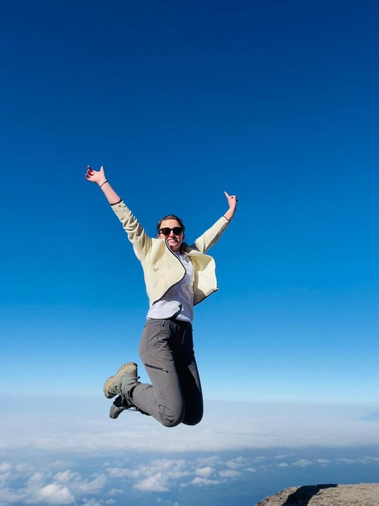 Person jumping against clear blue sky in kilimanjaro